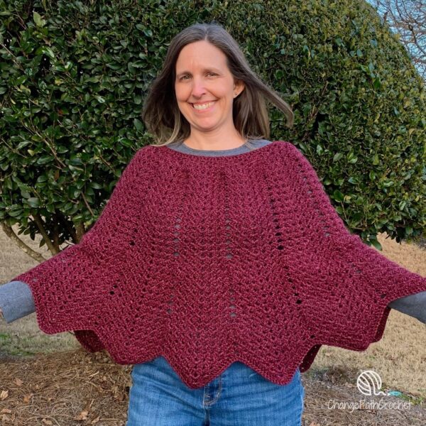 woman wearing zigzag poncho with open arms