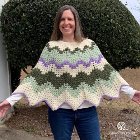 woman wearing zigzag poncho with open arms