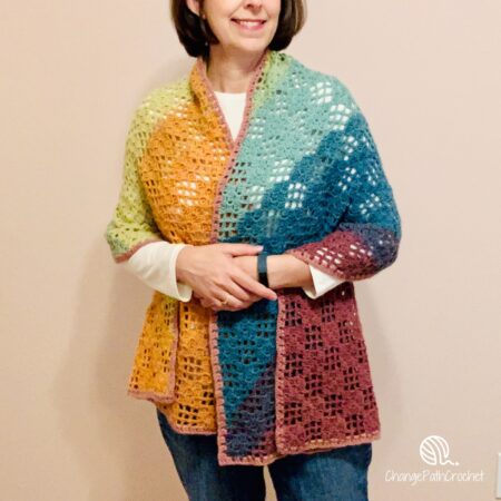 woman wearing a rainbow checkerboard shawl