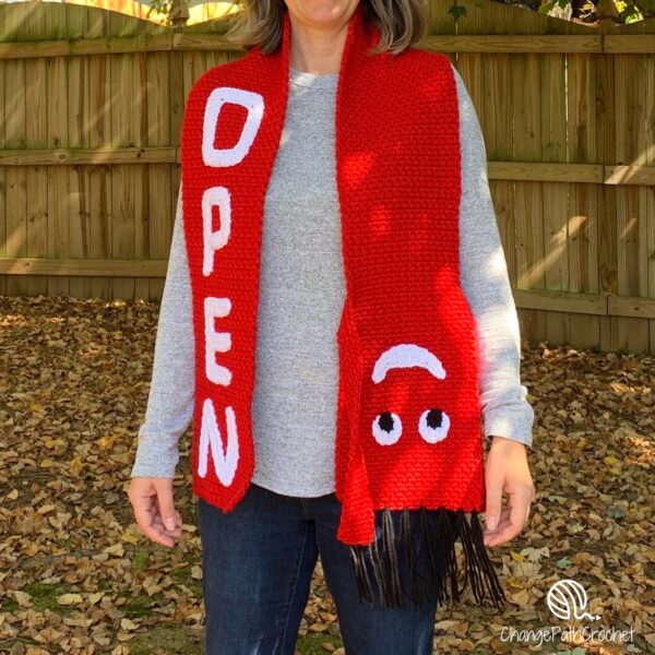 woman wearing tubeman scarf that says open