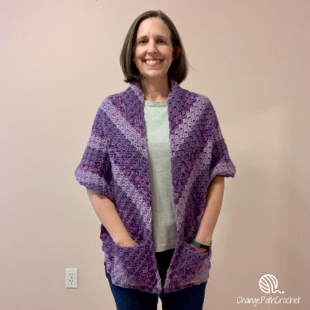 woman wearing purple striped shawl with pockets