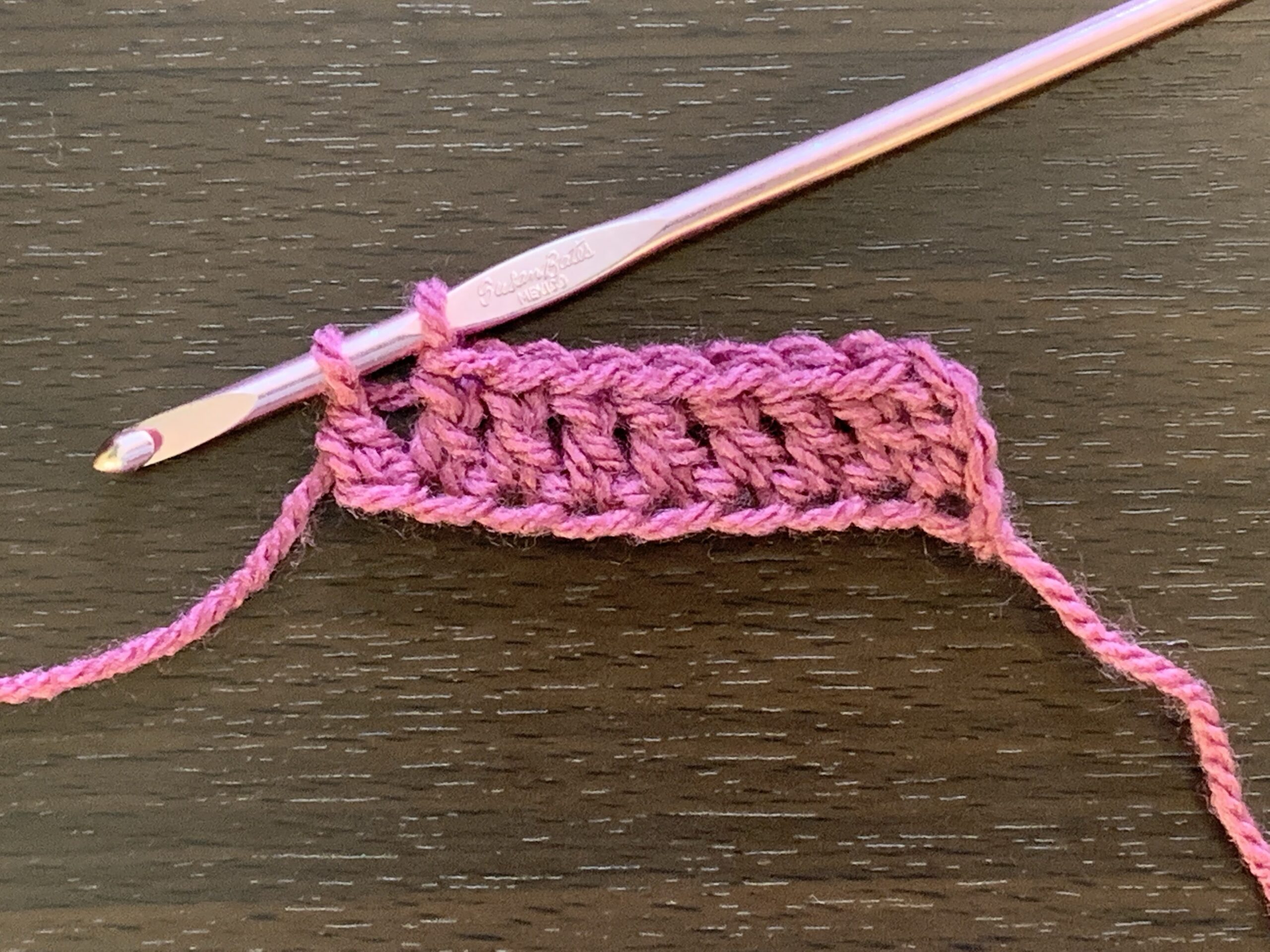 A set of double crochet stitches in progress.