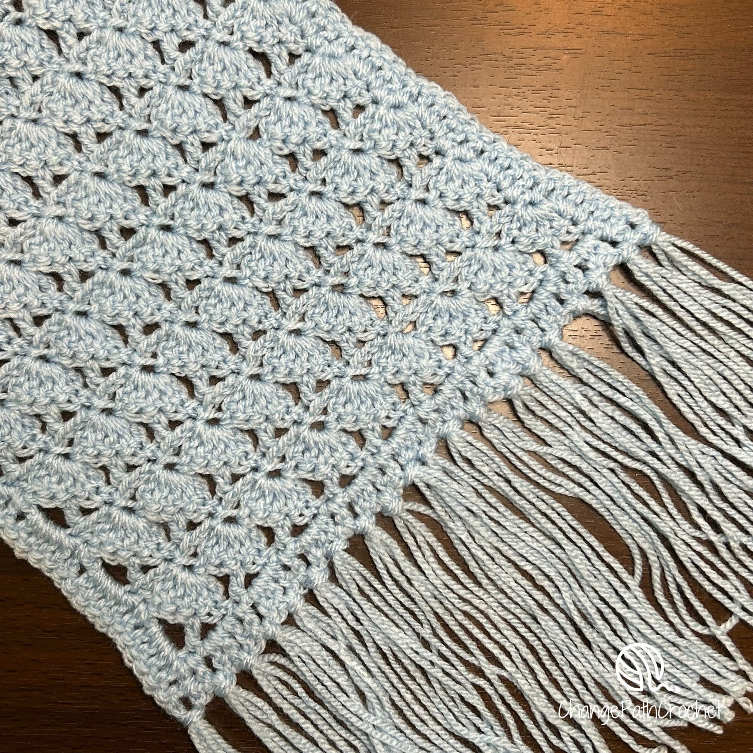 blue crocheted scarf with mushroom stitch and fringe