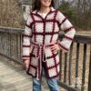 Woman wearing a plaid cardigan made with granny squares