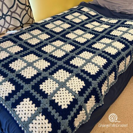 blue plaid blanket on a bed