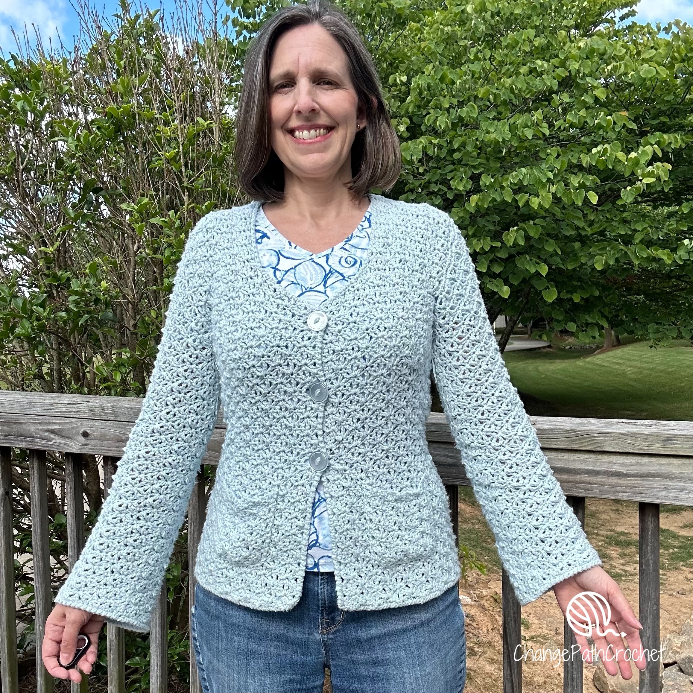 woman wearing light blue crochet cardigan